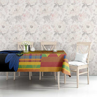 Kitenge-style tablecloth on table, navy floral with green yellow and red geometric stripes