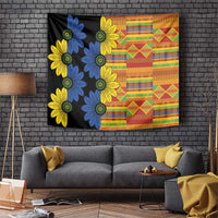 Black kitenge tapestry wall hanging with blue and yellow flower motifs plus orange patchwork grid