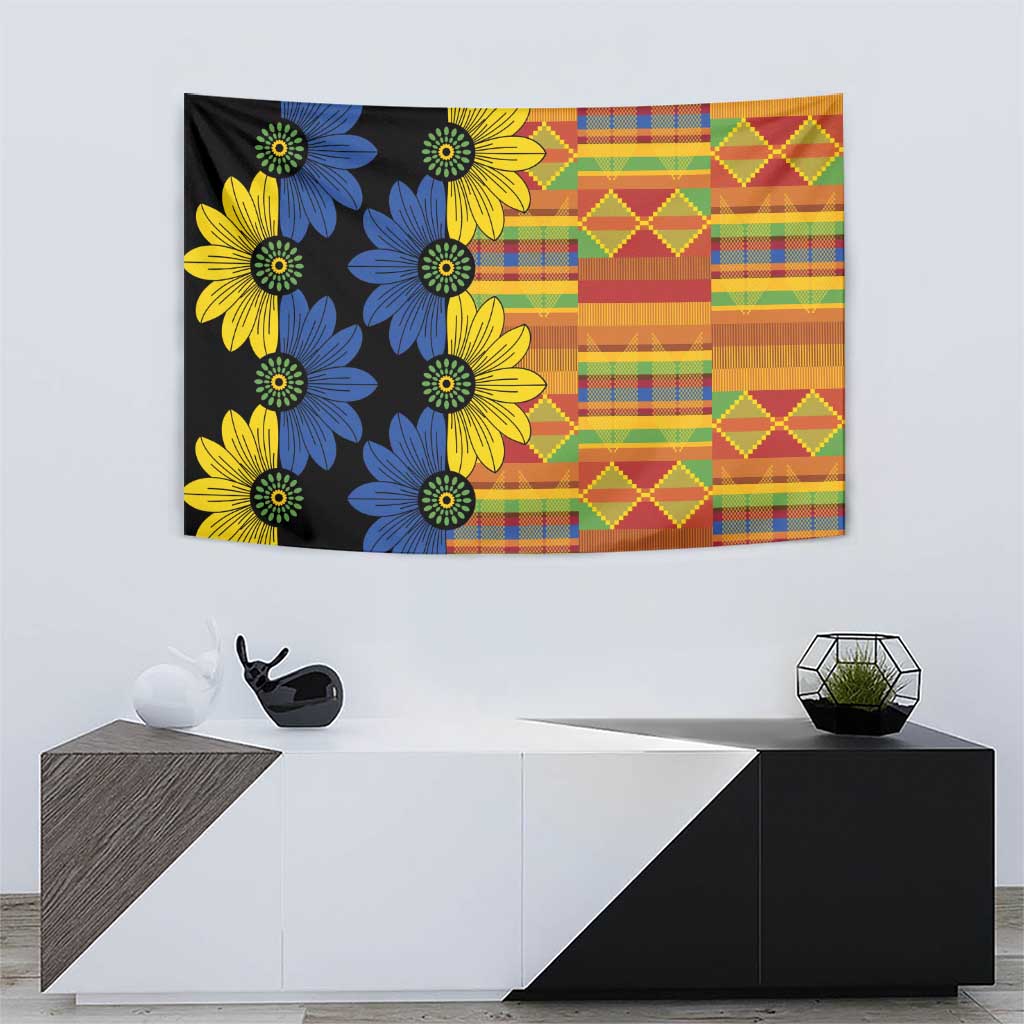Black kitenge tapestry with blue and yellow daisies on left and patterned blocks on right