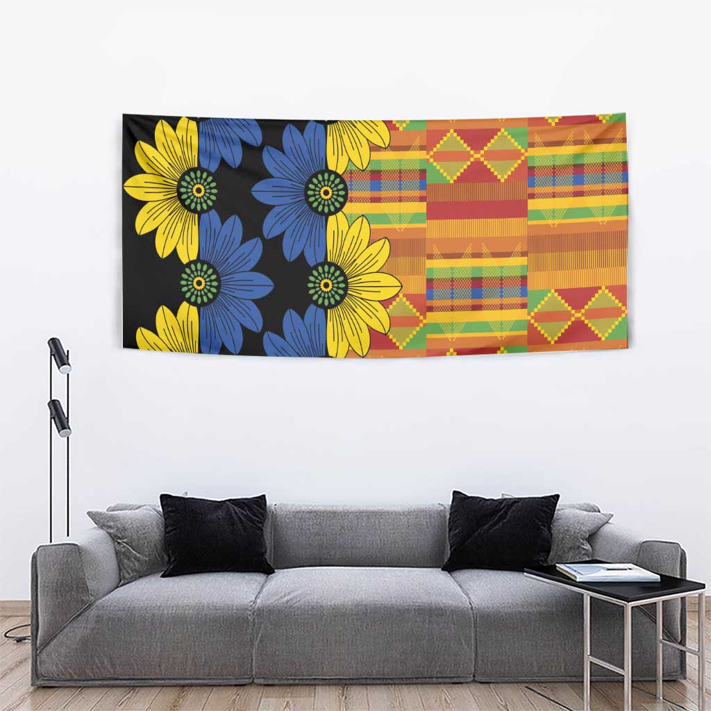 Black kitenge tapestry wall hanging with blue and yellow daisies and multicolor patchwork panel
