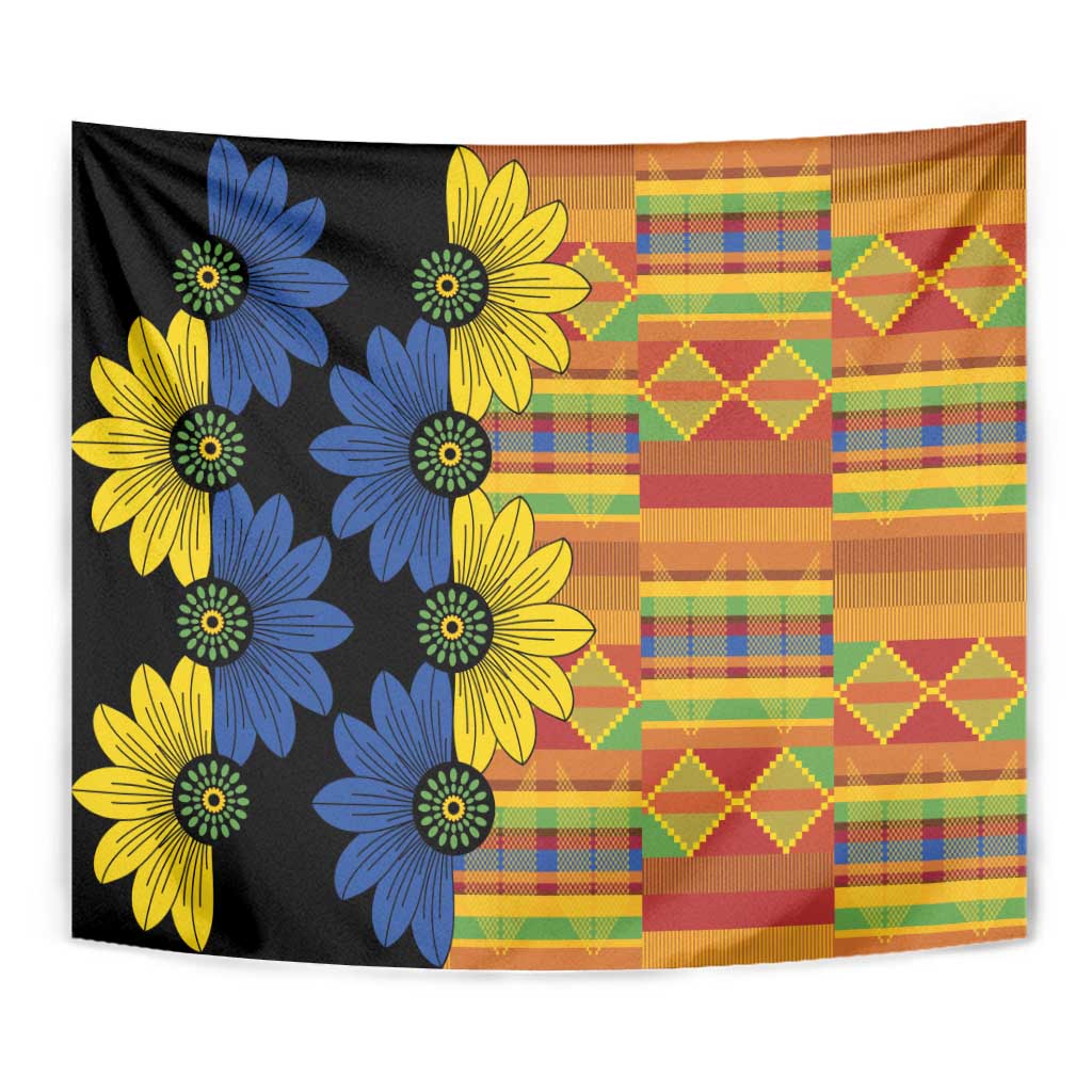 Black kitenge tapestry close-up with blue and yellow flower clusters and orange patchwork right side