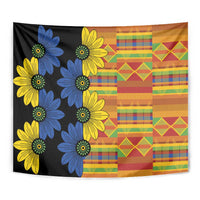 Black kitenge tapestry close-up with blue and yellow flower clusters and orange patchwork right side