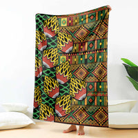 Folded multicolor kanga-style blanket featuring geometric and fan motifs on black base