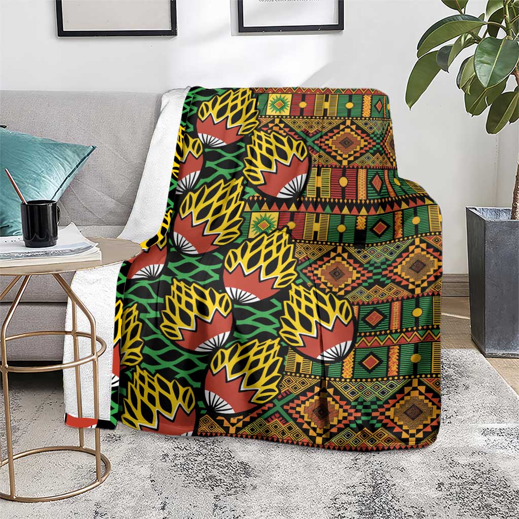 Kanga pattern blanket with bold geometric borders, fans, and diamond motifs in multicolor