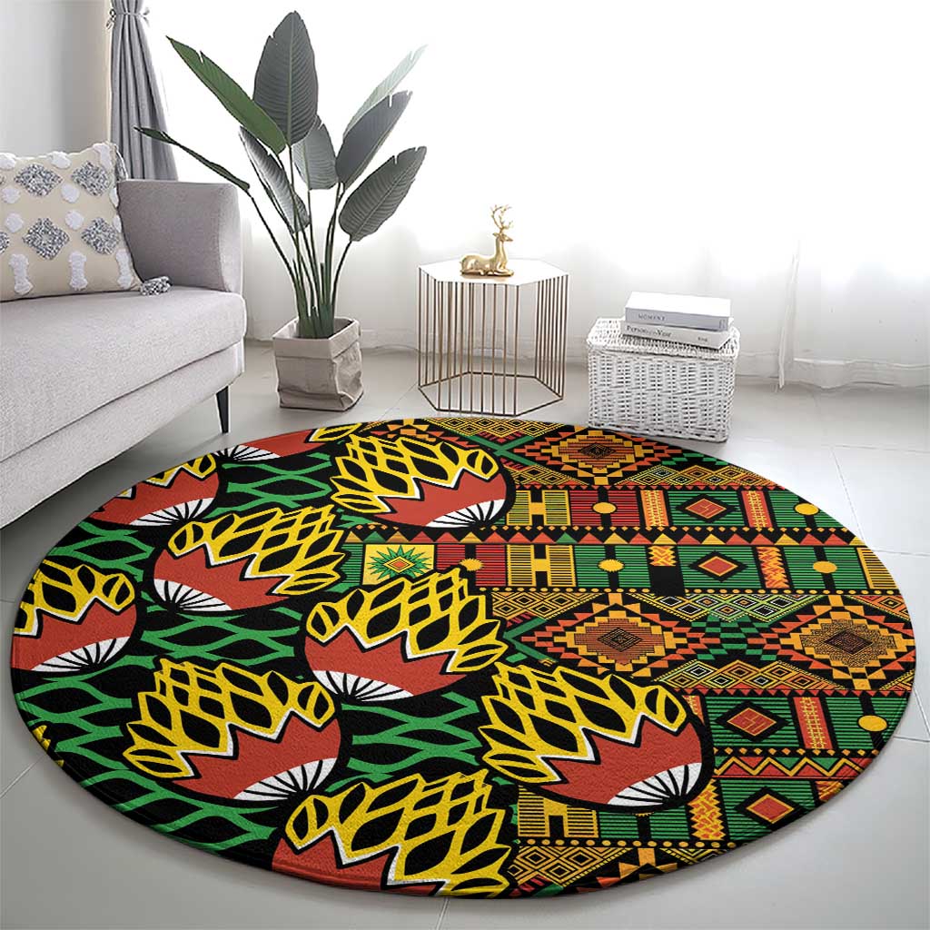 Round kanga pattern carpet laid on living room floor, black with green and warm multicolor print
