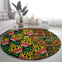 Round kanga pattern carpet laid on living room floor, black with green and warm multicolor print