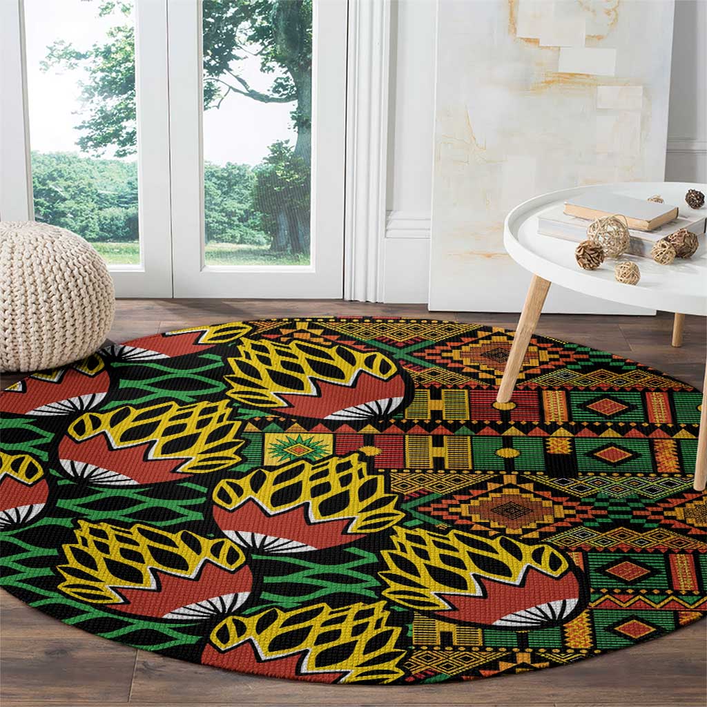 Round kanga pattern carpet near window, black with green, yellow, and rust geometric bands