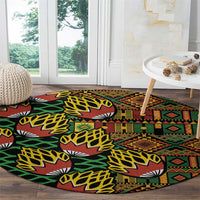 Round kanga pattern carpet near window, black with green, yellow, and rust geometric bands
