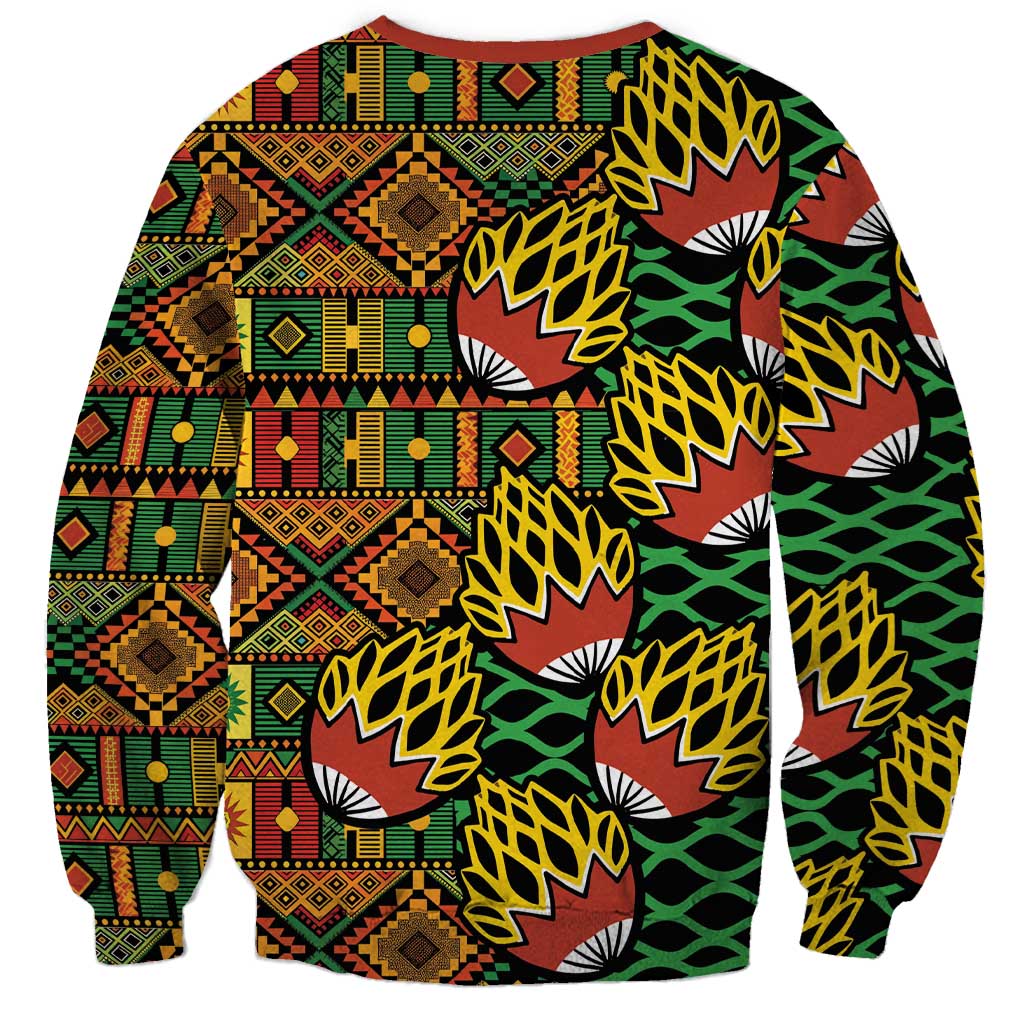 Unisex crewneck sweatshirt with colorful geometric patchwork and leaf fan motifs, long sleeves.