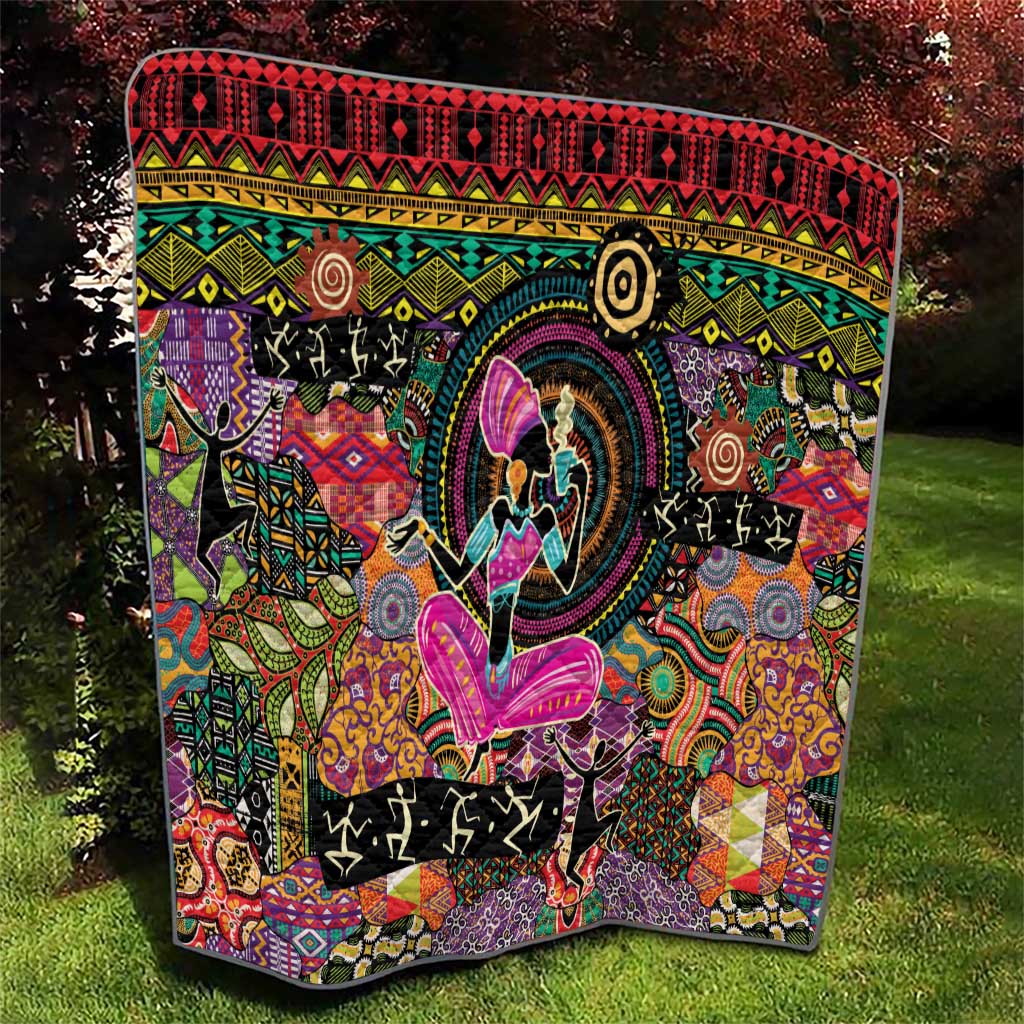 Black quilt blanket with swirling multicolor patterns and central purple butterfly figure