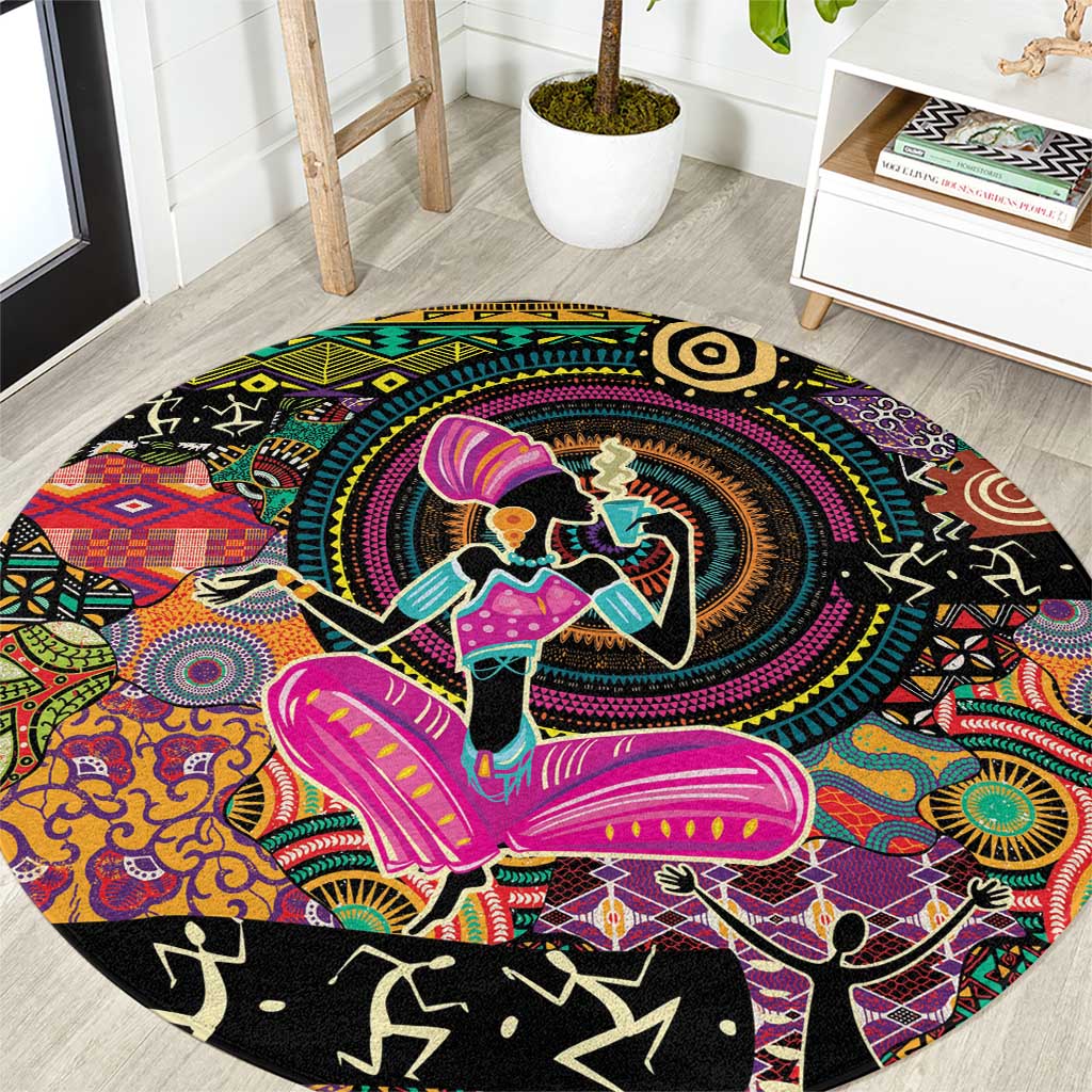 Round black ethnic motif area rug with colorful dancers and circular pattern center