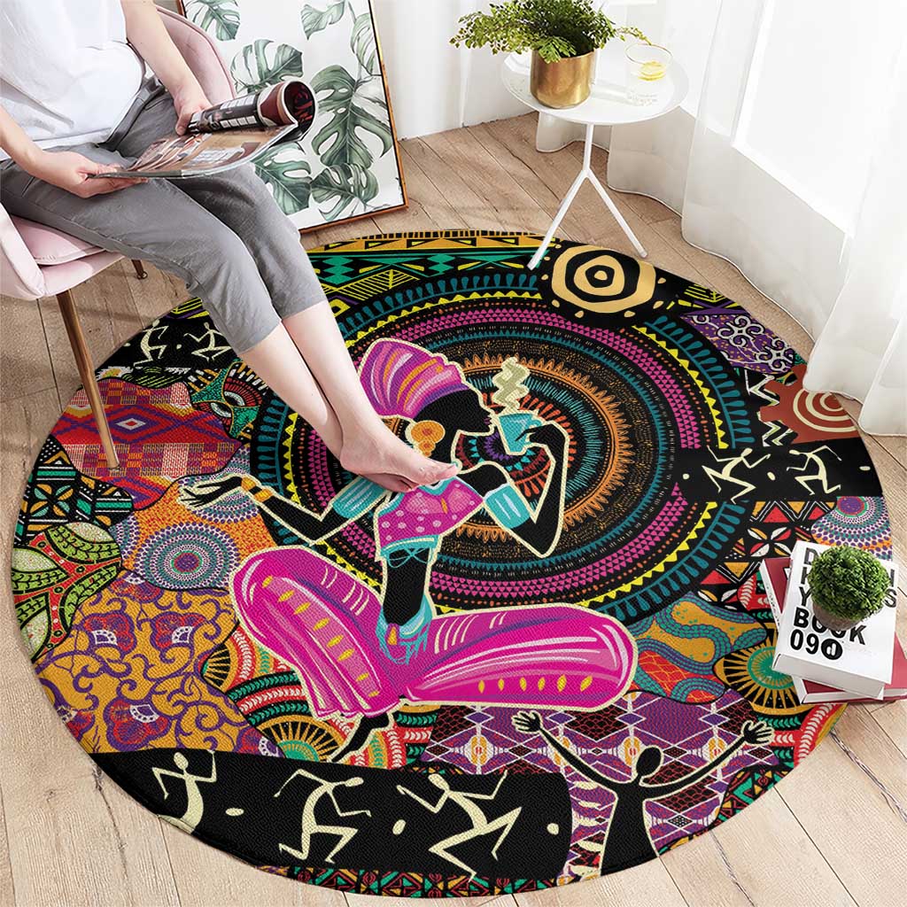 Round black area rug featuring vibrant African-style figures and tribal border motifs
