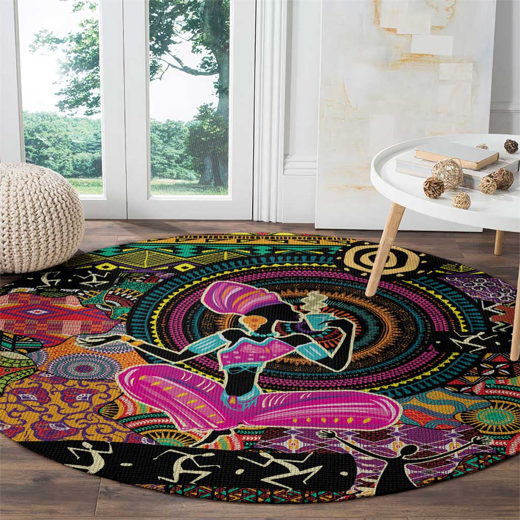 Round black rug with multicolor swirl medallion, dancer silhouettes, and tribal accents