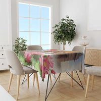 Rectangular tablecloth with pink lotus flowers and green leaf pattern draped over dining table