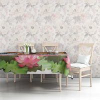 Lotus-themed tablecloth with green leaves and pink flowers on dining table setting