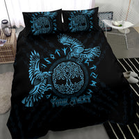 Black and blue bedding set featuring raven wings, circular emblem, and two pillowcases