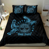 Black and blue duvet set with raven artwork, circular face emblem, and two pillowcases