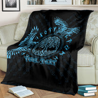 Black and blue raven throw blanket with Celtic knot pattern and customizable text, on a couch