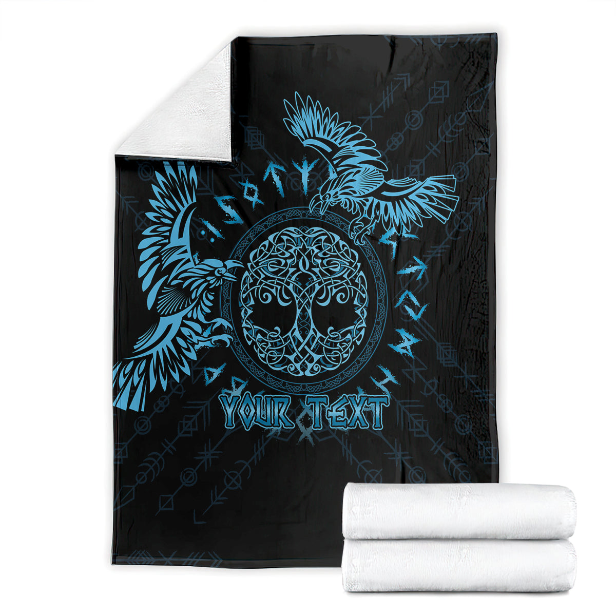 Black personalized blanket with blue raven artwork and customizable text, folded with towels