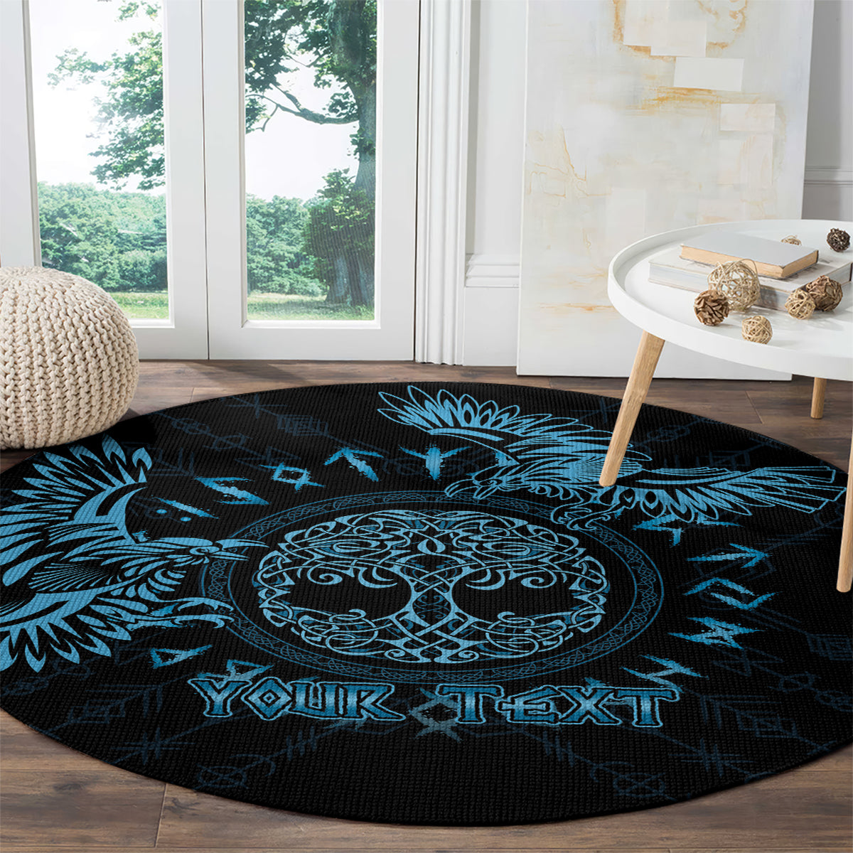 Round dark rug with blue Celtic raven circle artwork and "YOUR TEXT" near front.