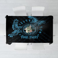 Personalized tablecloth with dark fabric, blue raven graphic, and center text area