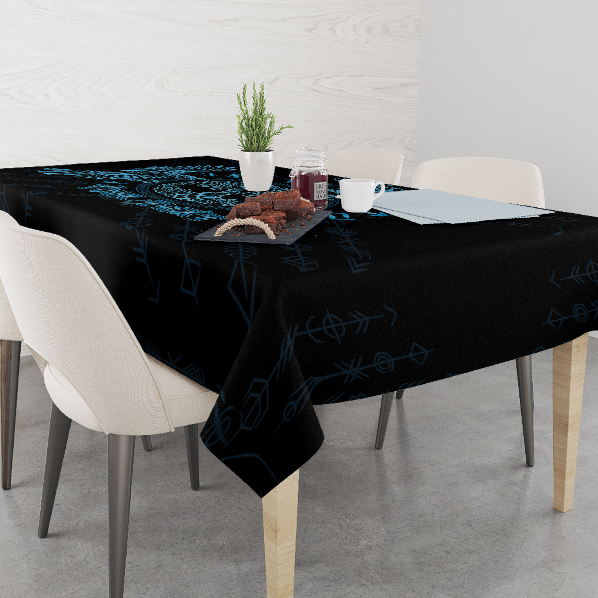 Rectangular tablecloth with dark fabric and blue rune-style pattern, draped over edges