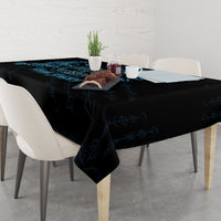 Rectangular tablecloth with dark fabric and blue rune-style pattern, draped over edges