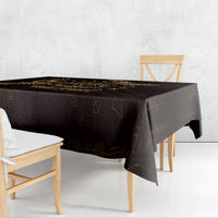 Personalized tablecloth in black with gold geometric Nordic symbols, draped over dining table