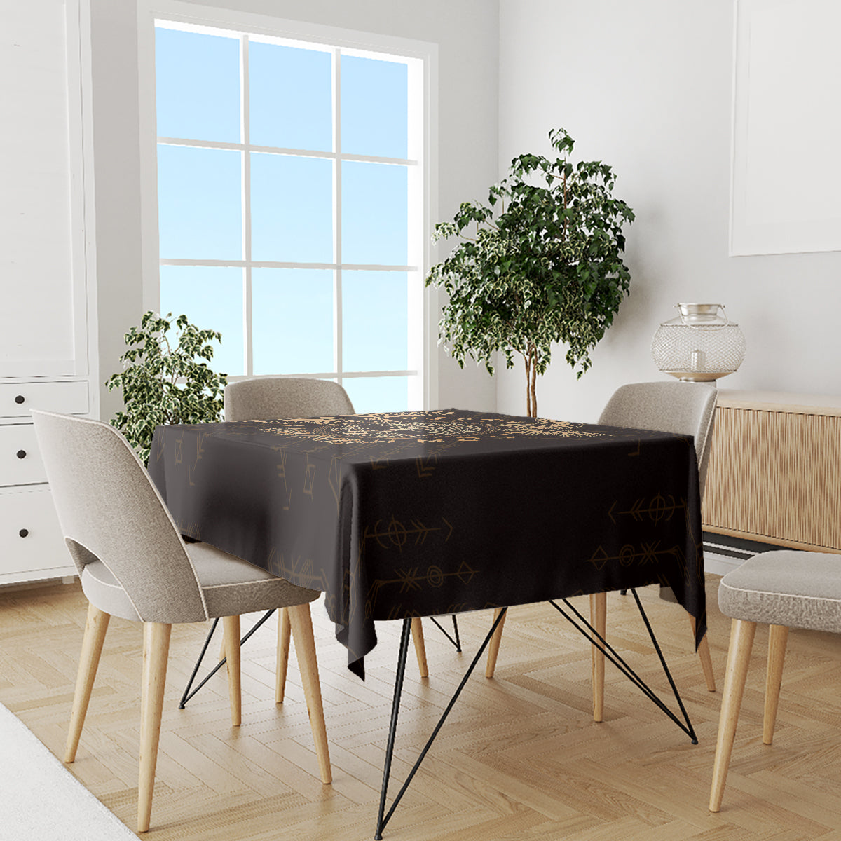 Personalized black tablecloth with gold rune-style symbols, on dining table with four chairs