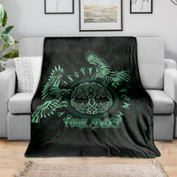 Personalized Odin's Celtic raven blanket draped on sofa, black with green raven and text