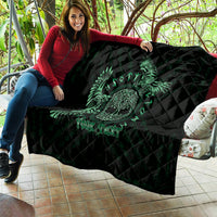 Person holding dark green and black Celtic raven quilt with custom text and quilted texture