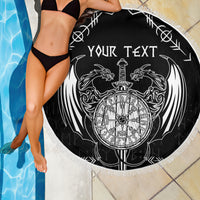 Black round beach blanket with white 'YOUR TEXT' dragon-and-sword emblem, fringed edge close-up