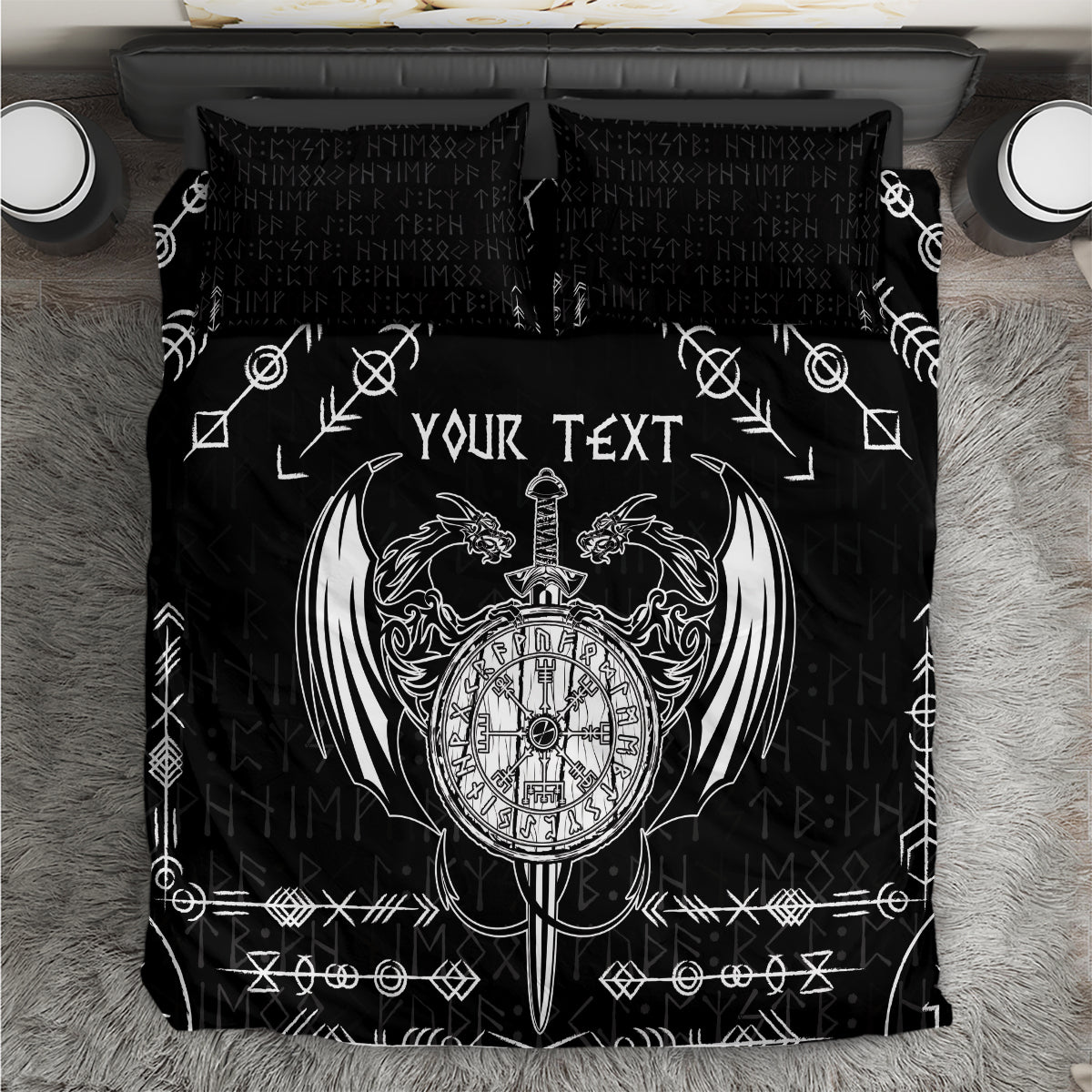 Black bedding set close-up with white Viking compass emblem and rune symbols on duvet.