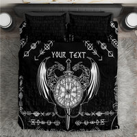 Black bedding set close-up with white Viking compass emblem and rune symbols on duvet.
