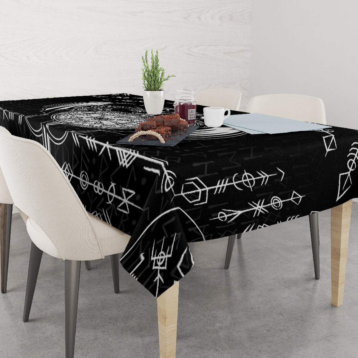 Black tablecloth with white geometric Viking icons, draped to table edges.