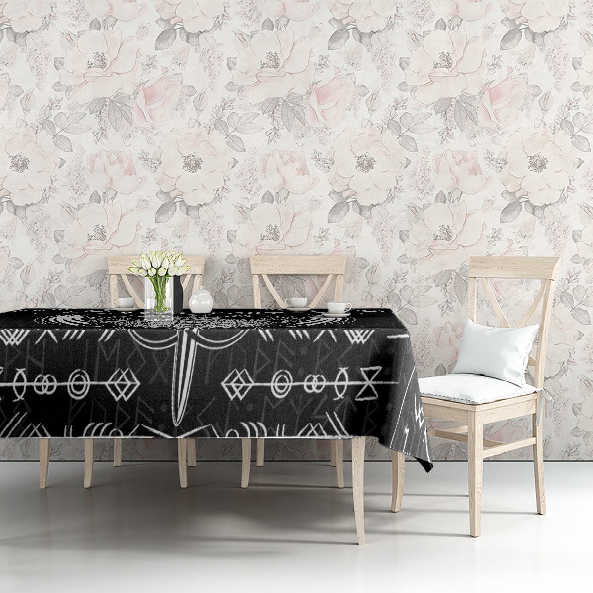 Black tablecloth with white Viking icons pattern, styled on a dining table.