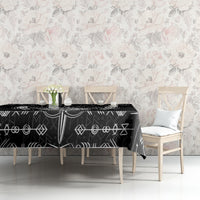 Black tablecloth with white Viking icons pattern, styled on a dining table.