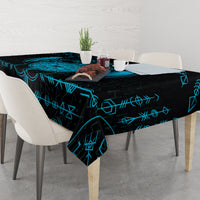 Blue and black Viking dragon tablecloth with blue rune lines on round dining table