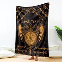 Viking dragon blanket draped, black with gold compass emblem and geometric border.
