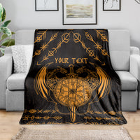 Viking dragon blanket across sofa, black with gold compass, wings, and “YOUR TEXT”.