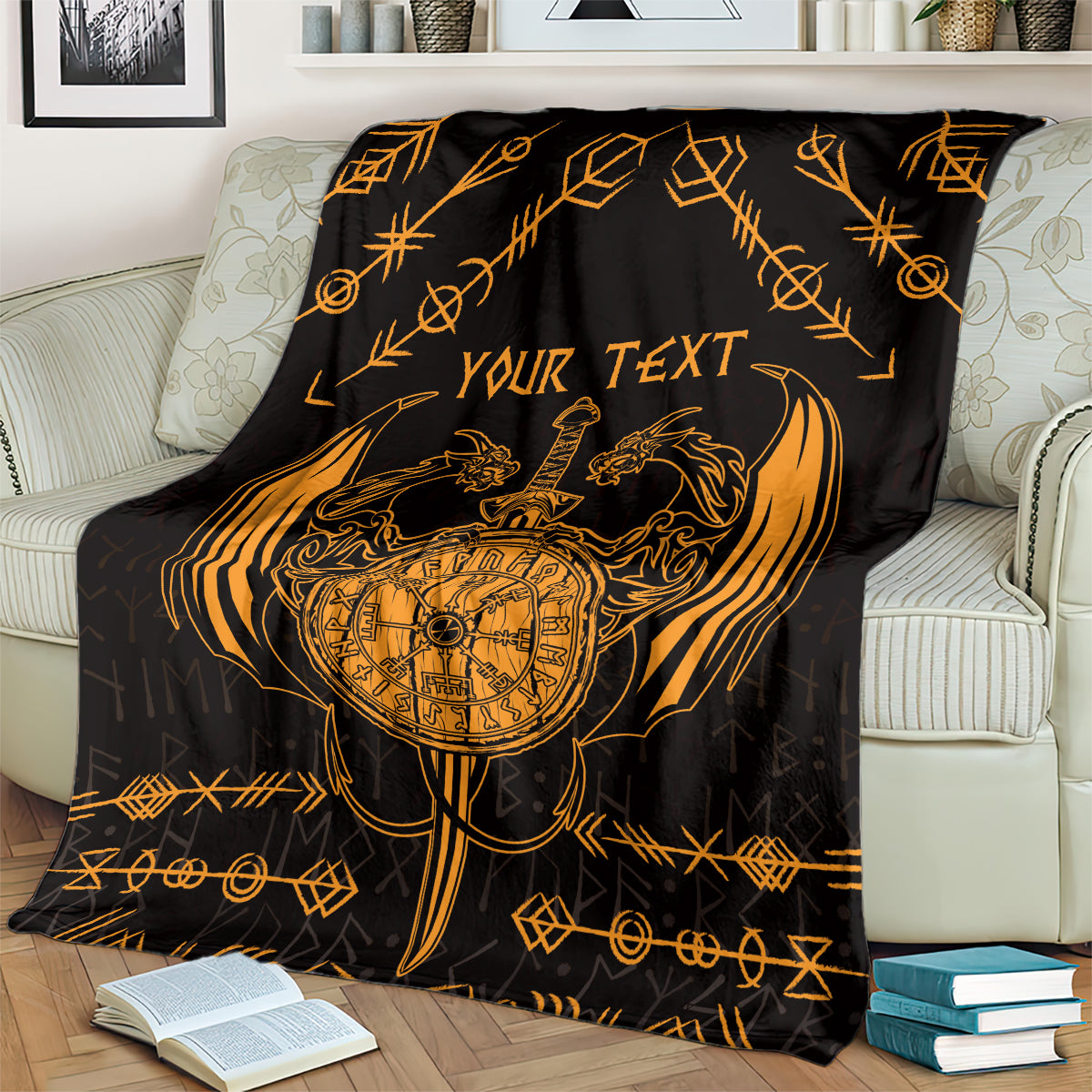 Viking dragon blanket on sofa, black with gold compass, dragon art, and “YOUR TEXT”.
