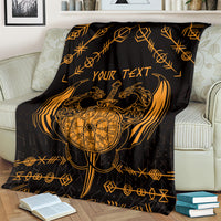 Viking dragon blanket on sofa, black with gold compass, dragon art, and “YOUR TEXT”.