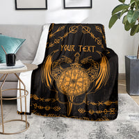 Viking dragon blanket on sofa, black with gold compass emblem, wings, and “YOUR TEXT”.