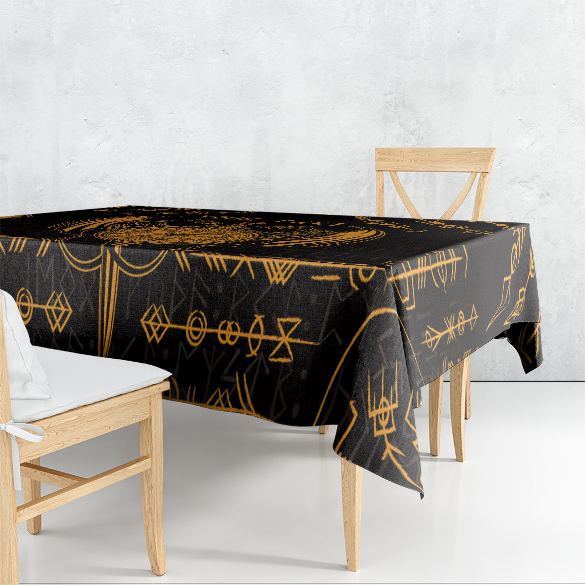 Black tablecloth with gold rune and geometric motifs on dining table