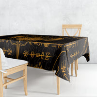 Black tablecloth with gold rune and geometric motifs on dining table