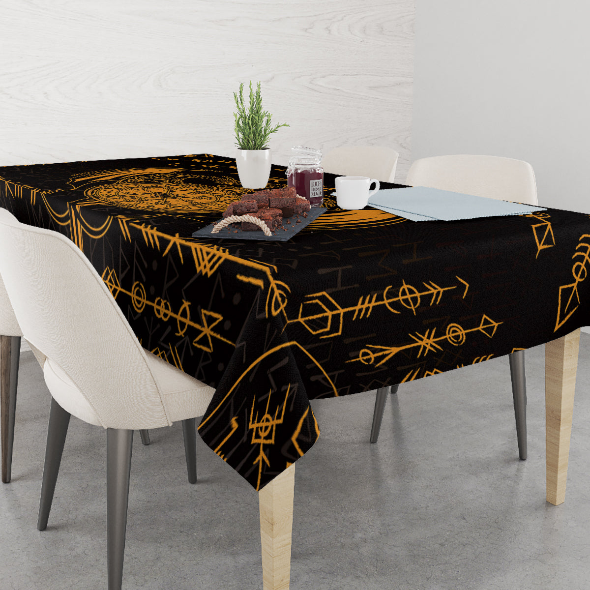 Black tablecloth with gold rune pattern, draped over dining table