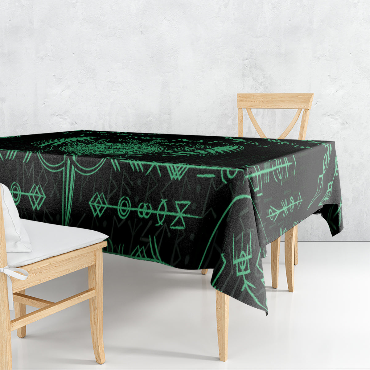 Black tablecloth draped over dining table with green rune symbols and sword motif
