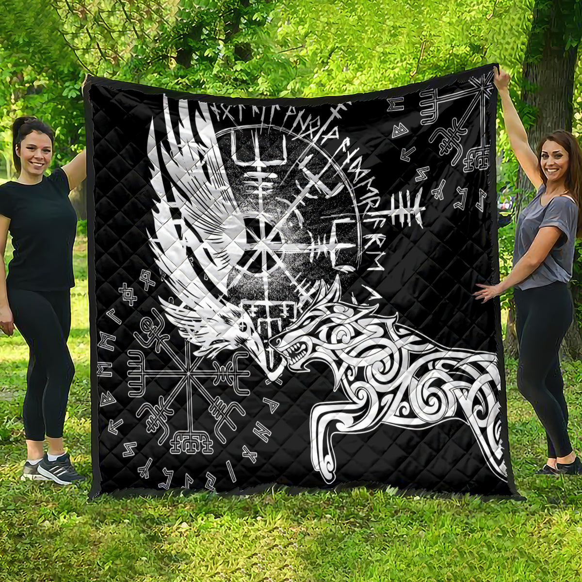 Black quilt with white raven-and-wolf graphic and rune symbols, quilted pattern.