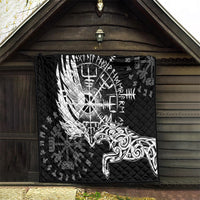 Black quilt hanging on wall with white raven-and-wolf graphic and rune symbols.