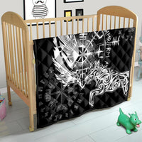 Black quilt over baby bed with white raven-and-wolf artwork and rune symbols.